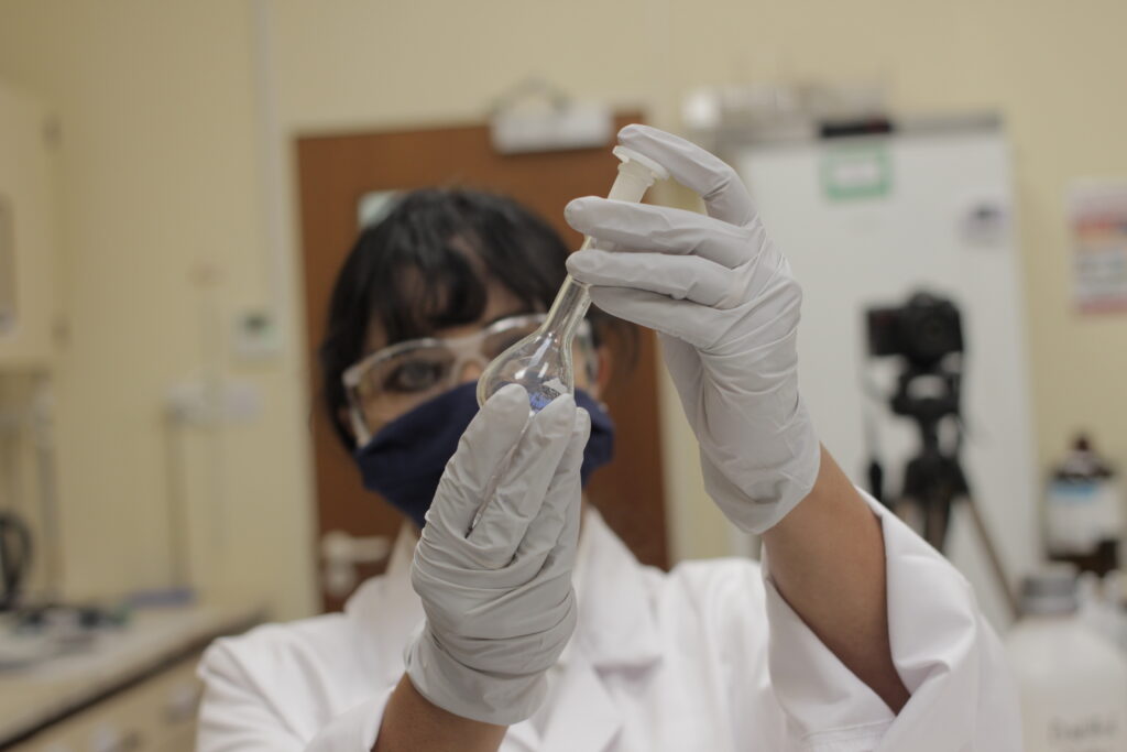 Employee holding a test tube on a storage stability blog